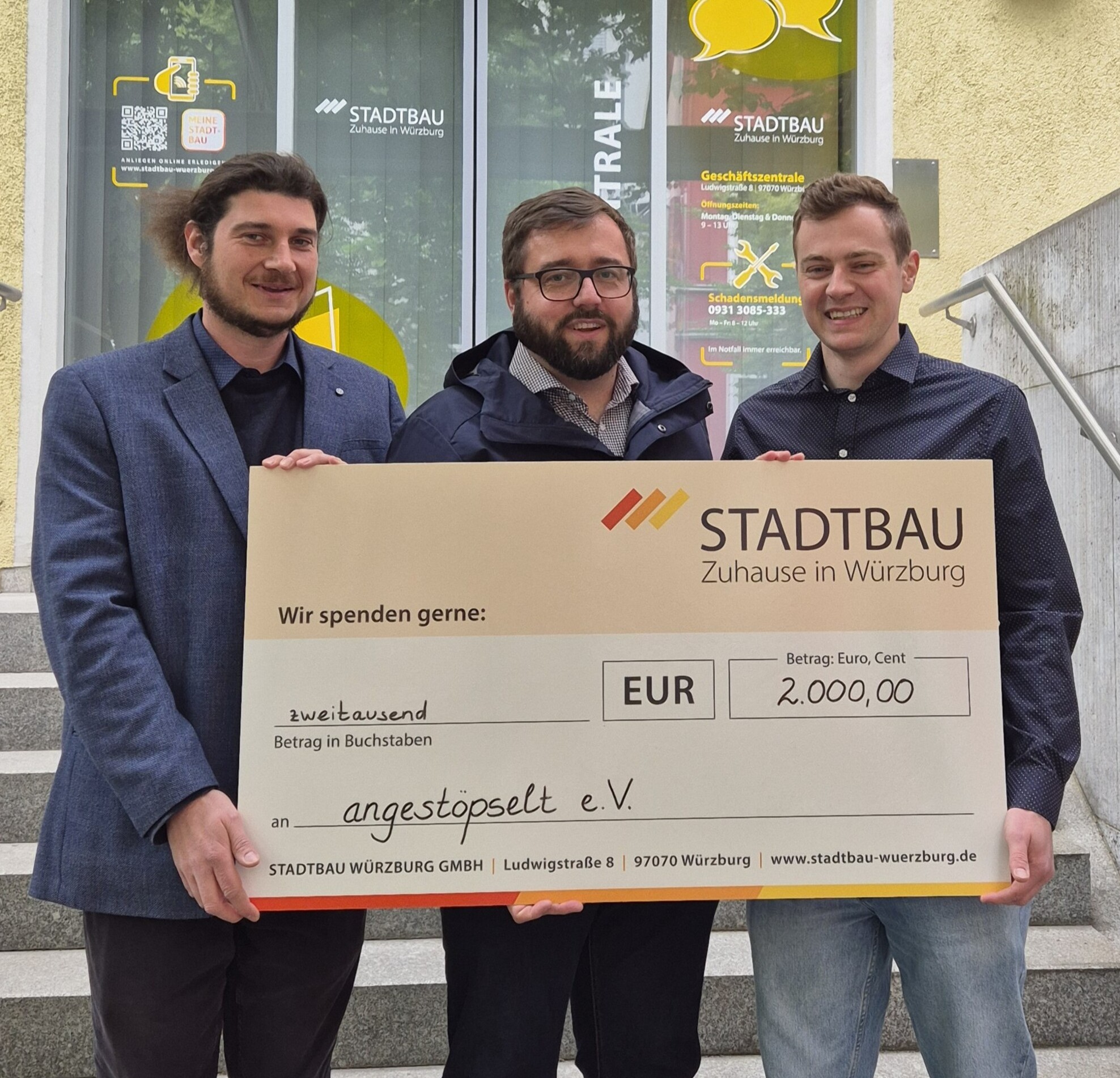 Das Bild zeigt die Spendenübergabe und 3 Personen mit einem großen Scheck über 2000 Euro.